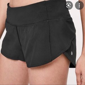 Black Lululemon shorts with tag and bag